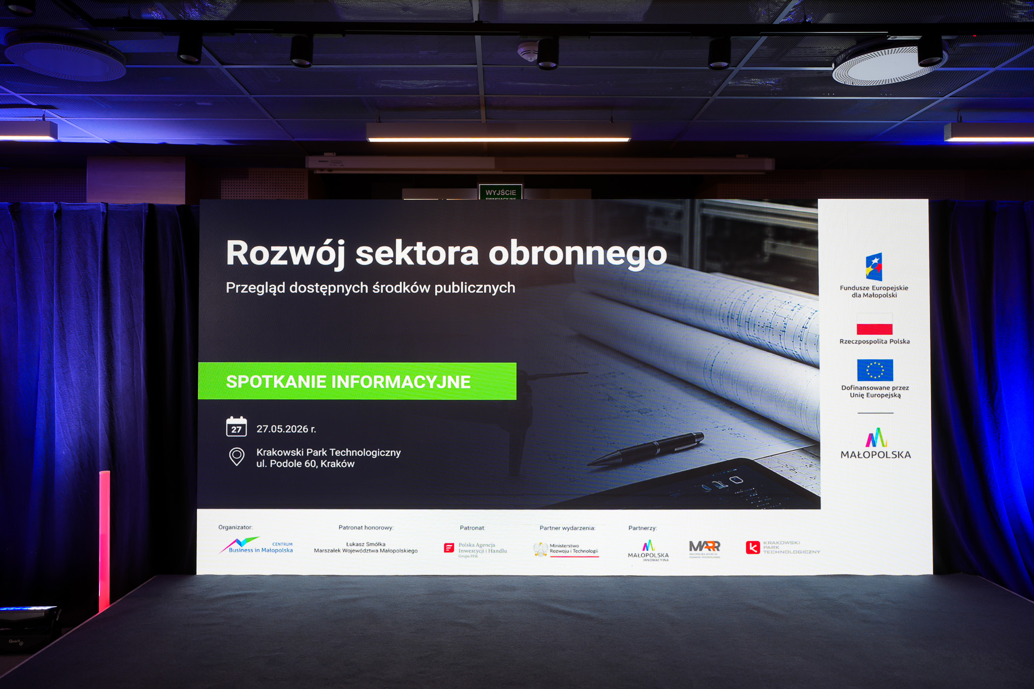 scena z ekranem na na nim wyświetlona nazwa wydarzenia